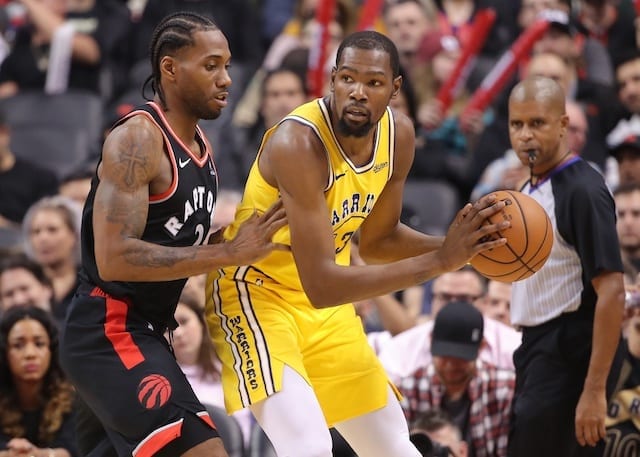 Golden State Warriors forward Kevin Durant is defended by Toronto Raptors forward Kawhi Leonard