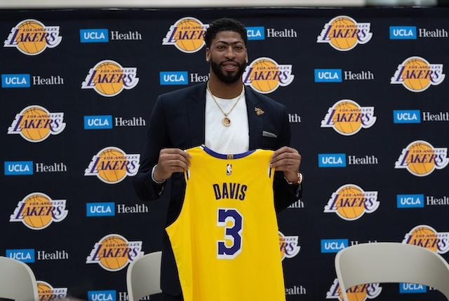 Los Angeles Lakers forward Anthony Davis holds his new No. 3 jersey during an introductory press conference